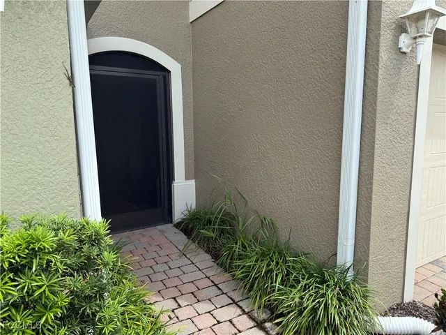 a couple of potted plants in front of door