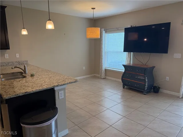 a living room with a couch and a potted plant