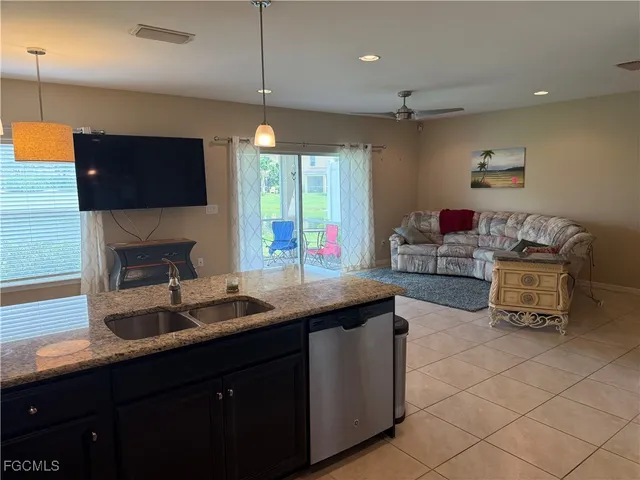 a kitchen with a sink and a stove top oven