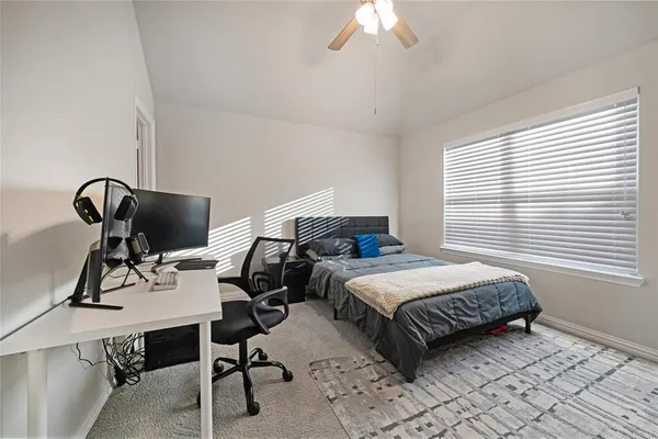 a bedroom with a workspace