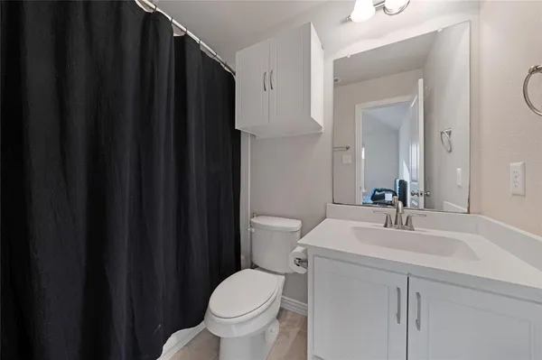 a bathroom with a sink a toilet a mirror and vanity