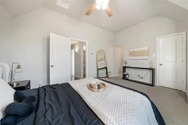 a bedroom with a bed and a chandelier