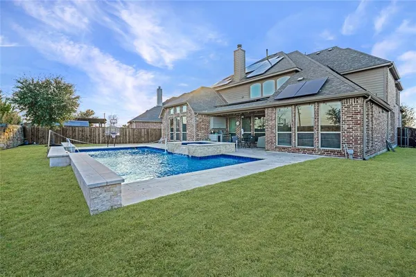 a view of a house with a yard balcony and seating space