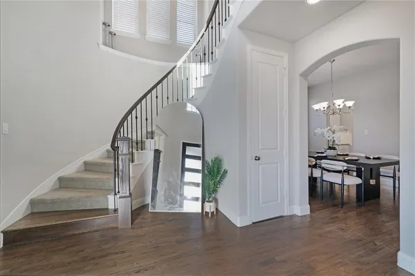 a view of entryway and hall with wooden floor