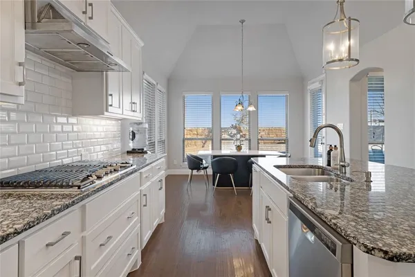 a kitchen with sink stove and cabinets