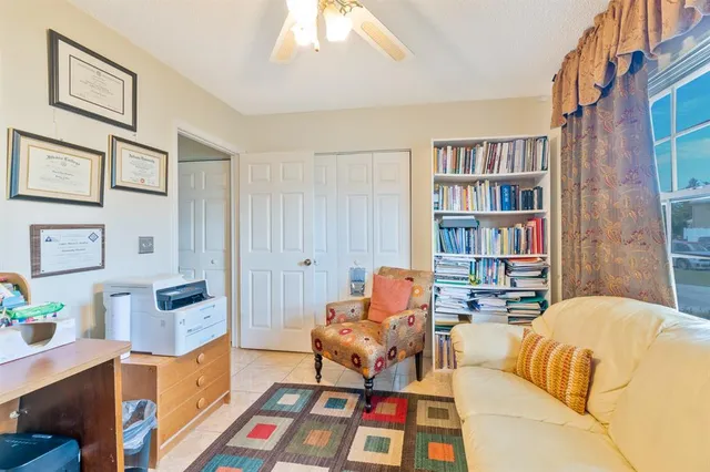 a bedroom with furniture and a book shelf