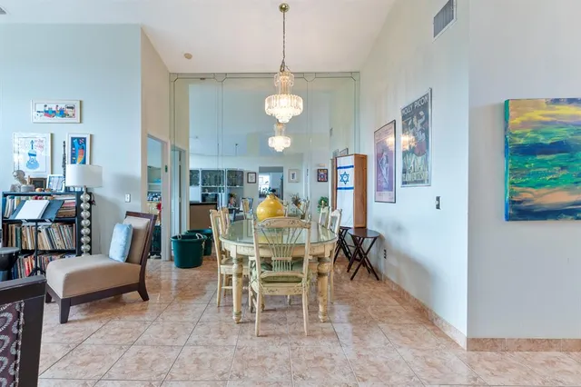 a view of a dining room with furniture and a chandelier