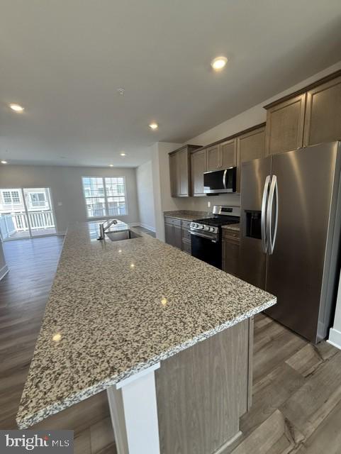 7608 River Reach Road Baltimore, MD 21244 - Photo 6 of 14 a kitchen with stainless steel appliances granite countertop refrigerator sink and stove