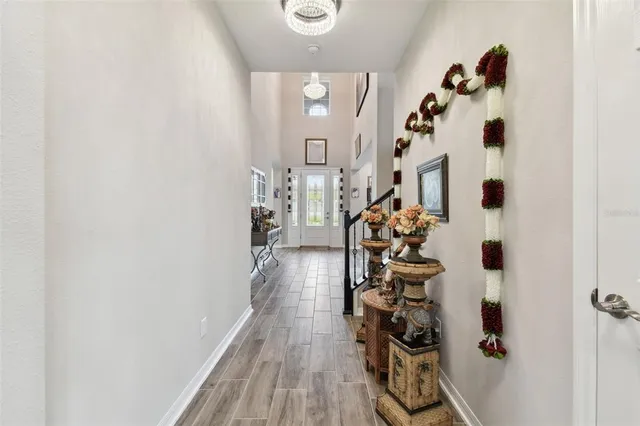 a large kitchen with stainless steel appliances a sink and a wooden floor