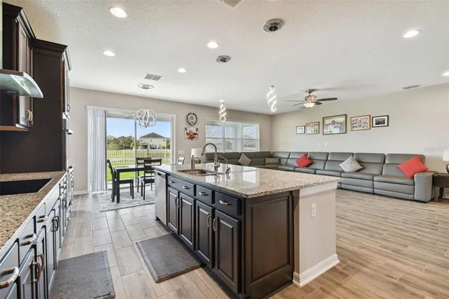 a living room with furniture a flat screen tv and a table