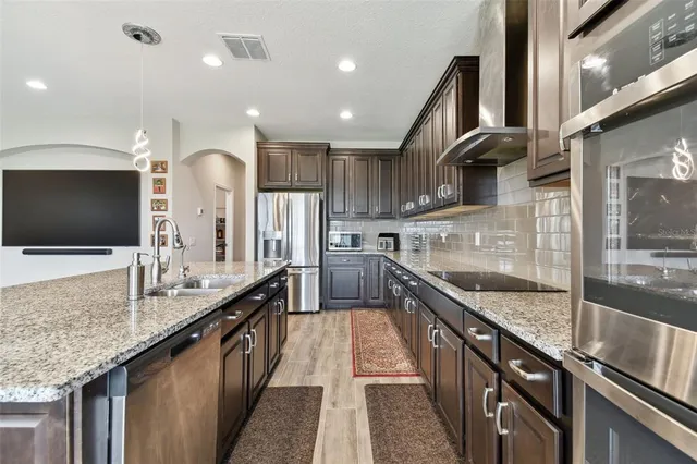 a living room with furniture a rug and a flat screen tv