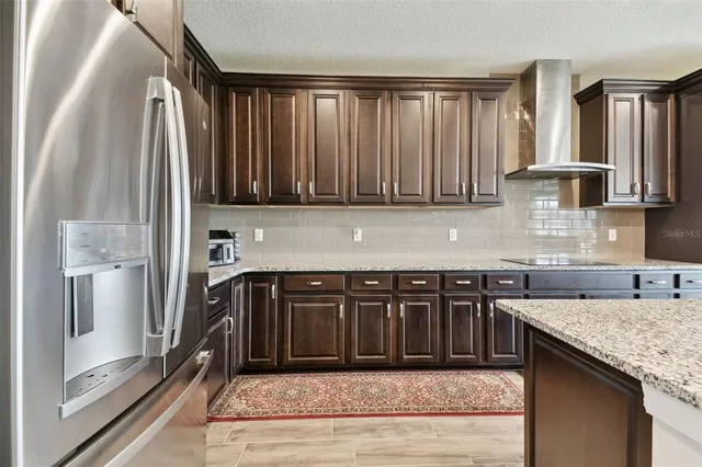 a bathroom with a granite countertop sink a mirror and a shower