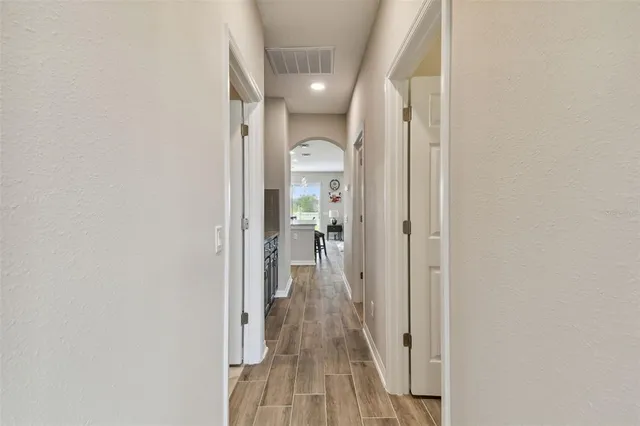 a spacious bedroom with a bed and a lamp