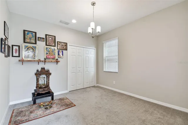 a bedroom with a bed and a chair in it