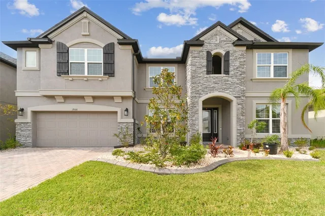 a front view of a house with a yard and garage