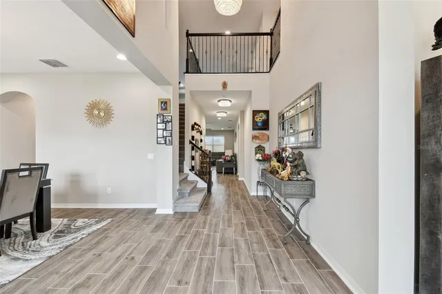 a view of a dining room with furniture wooden floor and chandelier