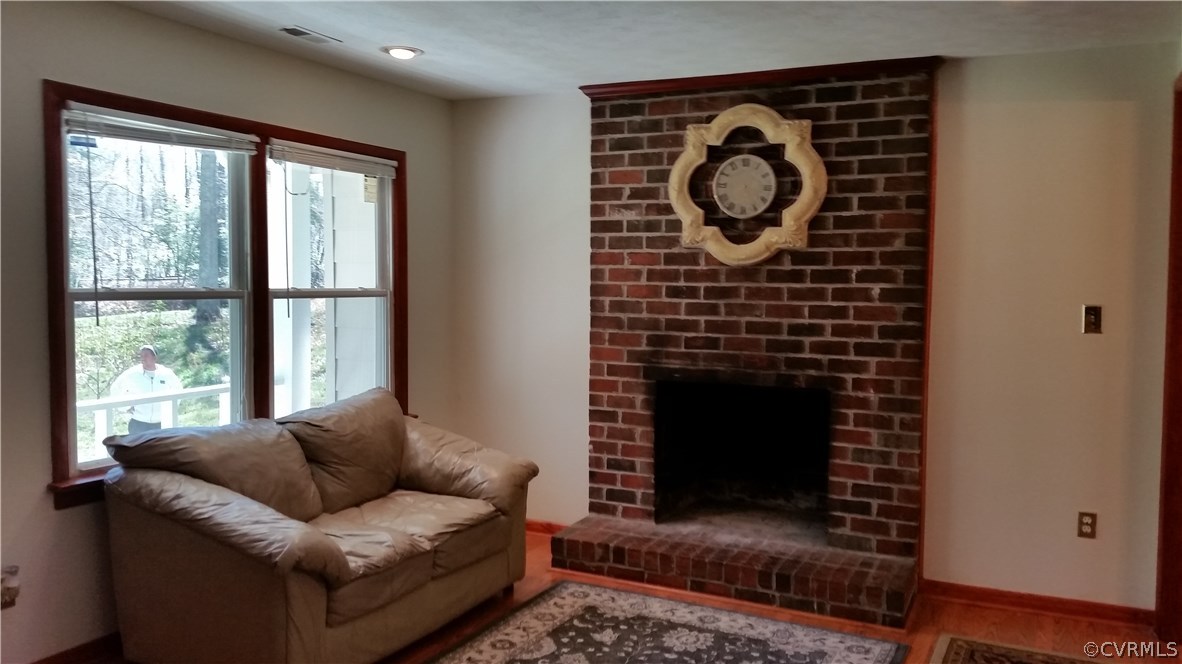 9420 Cosby Mill Road Quinton, VA 23141 - Photo 7 of 19 a living room with furniture a rug and a fireplace