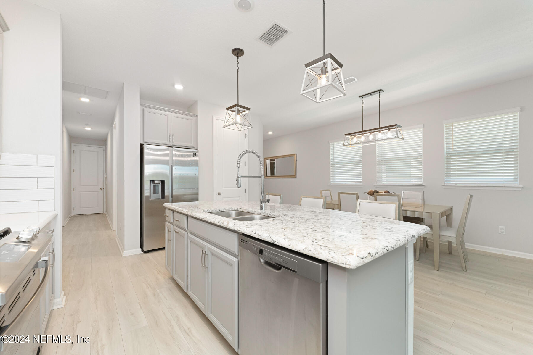 10279 Innovation Way Jacksonville, FL 32256 - Photo 11 of 42 a kitchen with stainless steel appliances kitchen island a chandelier