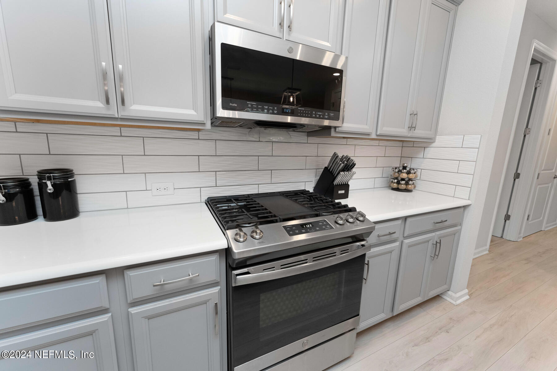 10279 Innovation Way Jacksonville, FL 32256 - Photo 12 of 42 a kitchen with stainless steel appliances granite countertop a sink a stove a microwave and cabinets