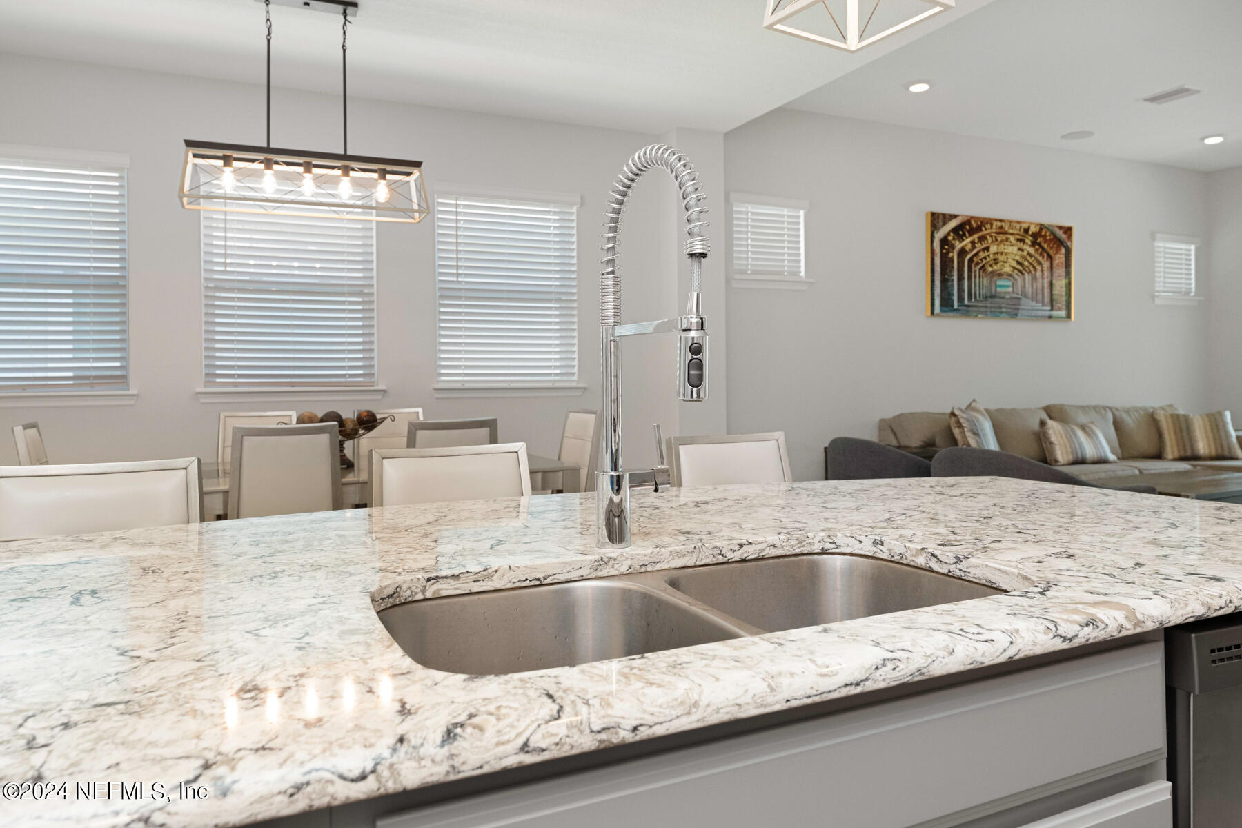 10279 Innovation Way Jacksonville, FL 32256 - Photo 14 of 42 a kitchen with a granite countertop sink and natural light