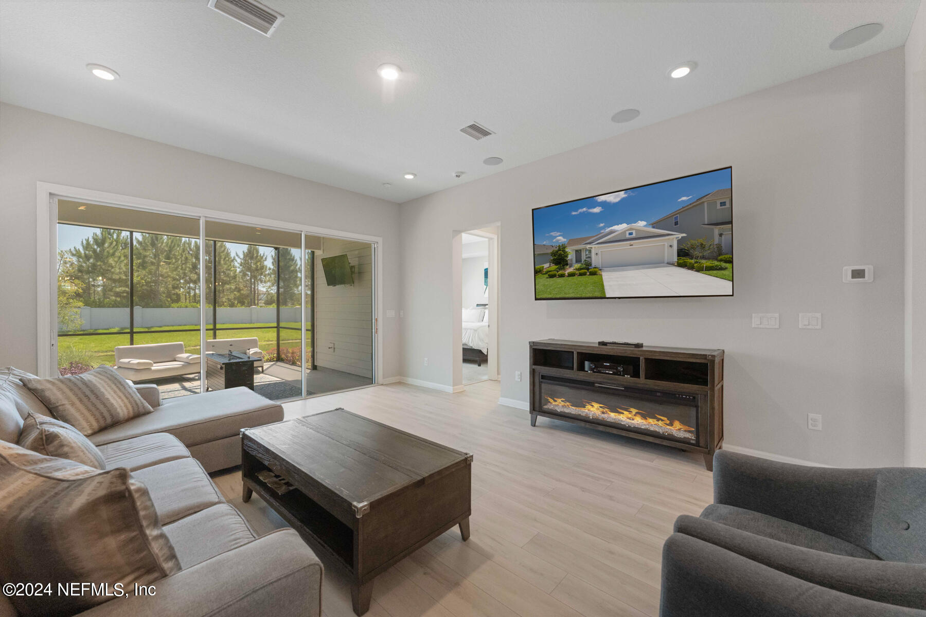 10279 Innovation Way Jacksonville, FL 32256 - Photo 17 of 42 a living room with furniture and a flat screen tv