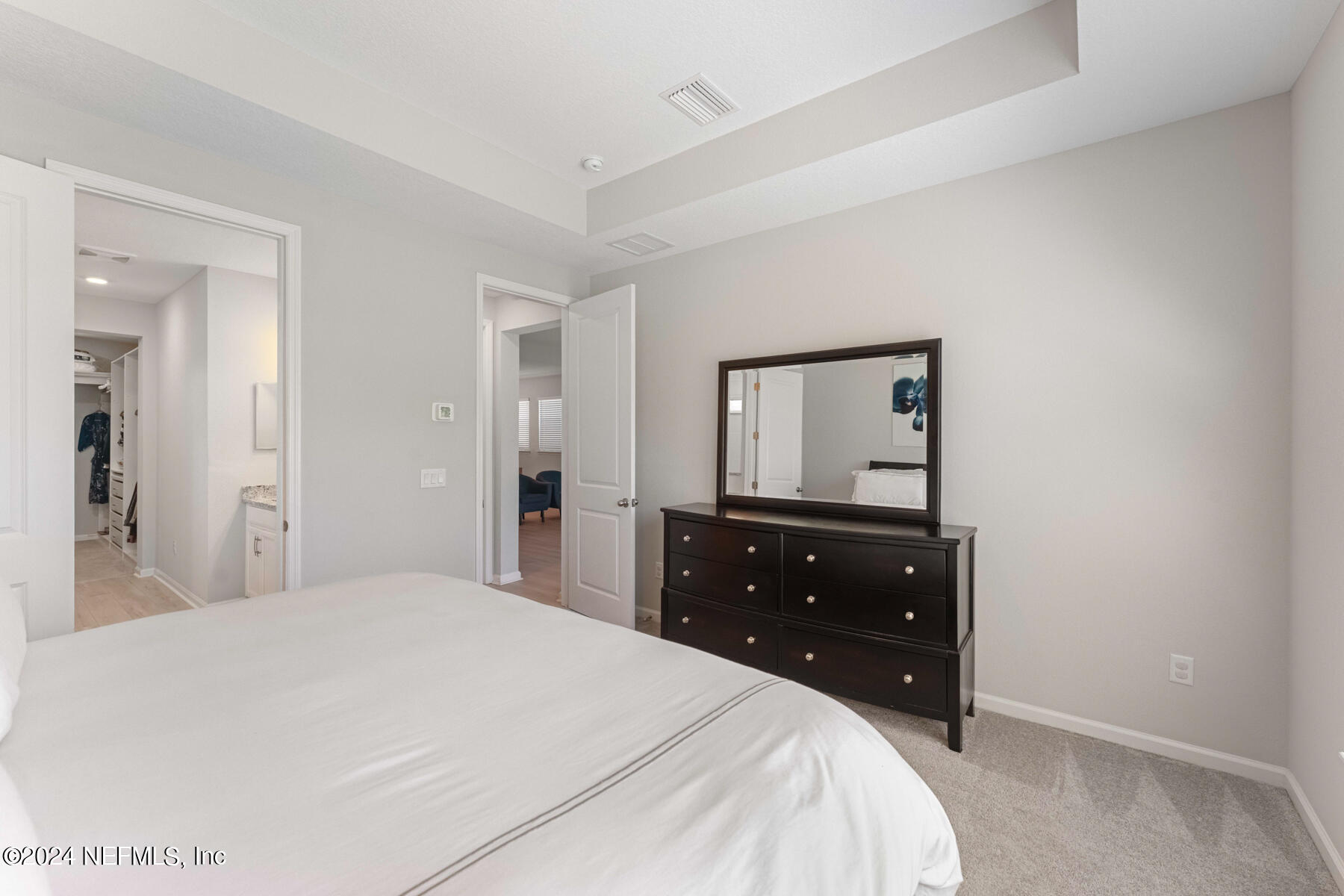 10279 Innovation Way Jacksonville, FL 32256 - Photo 19 of 42 a bedroom with a bed and a dresser