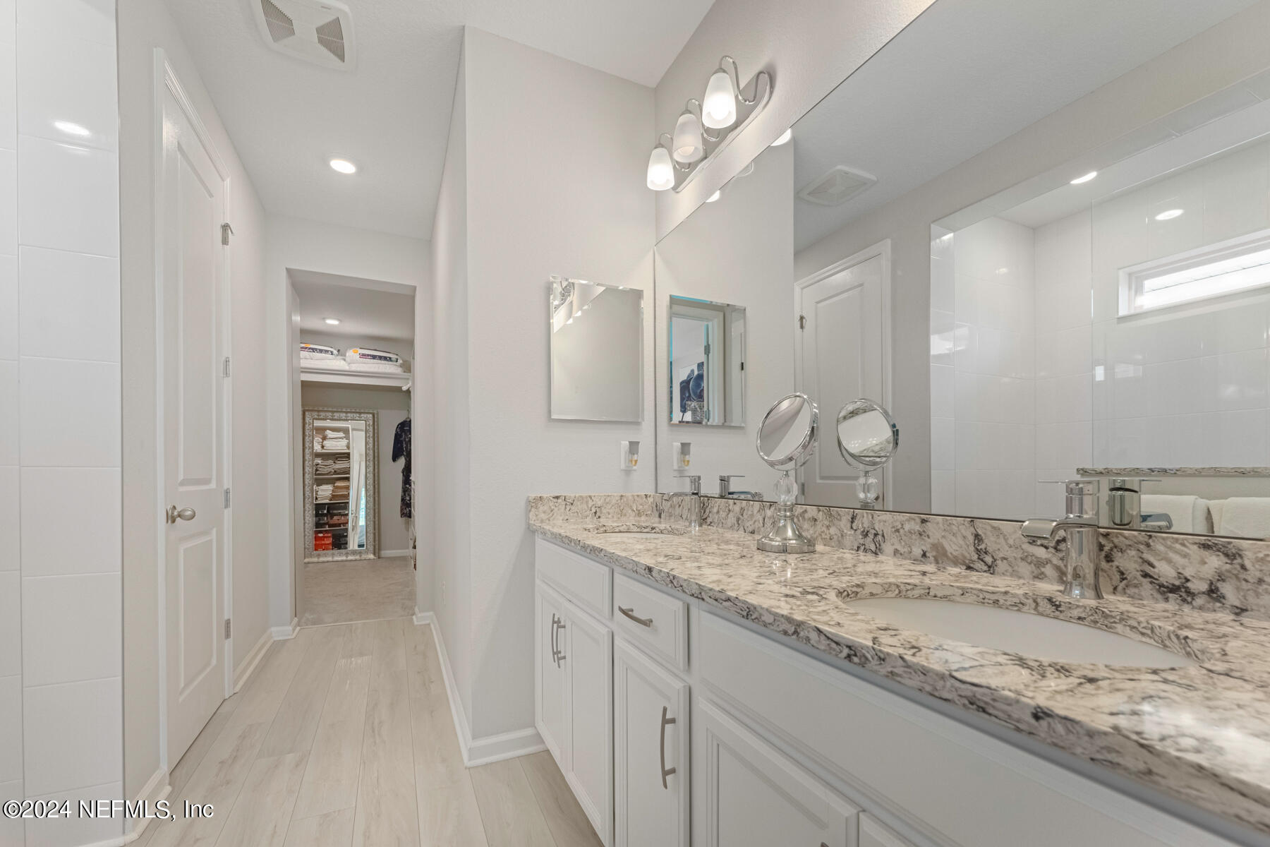 10279 Innovation Way Jacksonville, FL 32256 - Photo 20 of 42 a spacious bathroom with a granite countertop sink a mirror and a shower