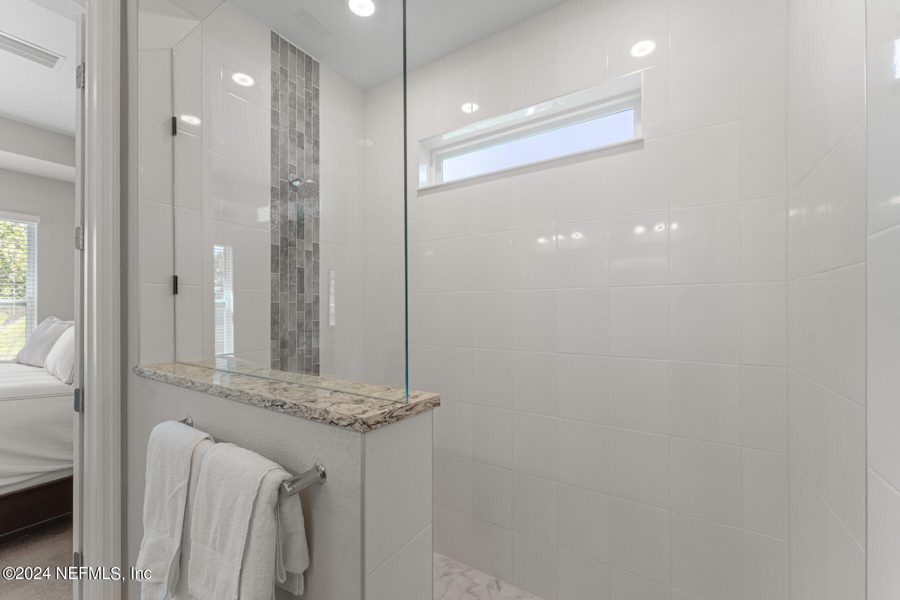 10279 Innovation Way Jacksonville, FL 32256 - Photo 21 of 42 a bathroom with a mirror and a shower