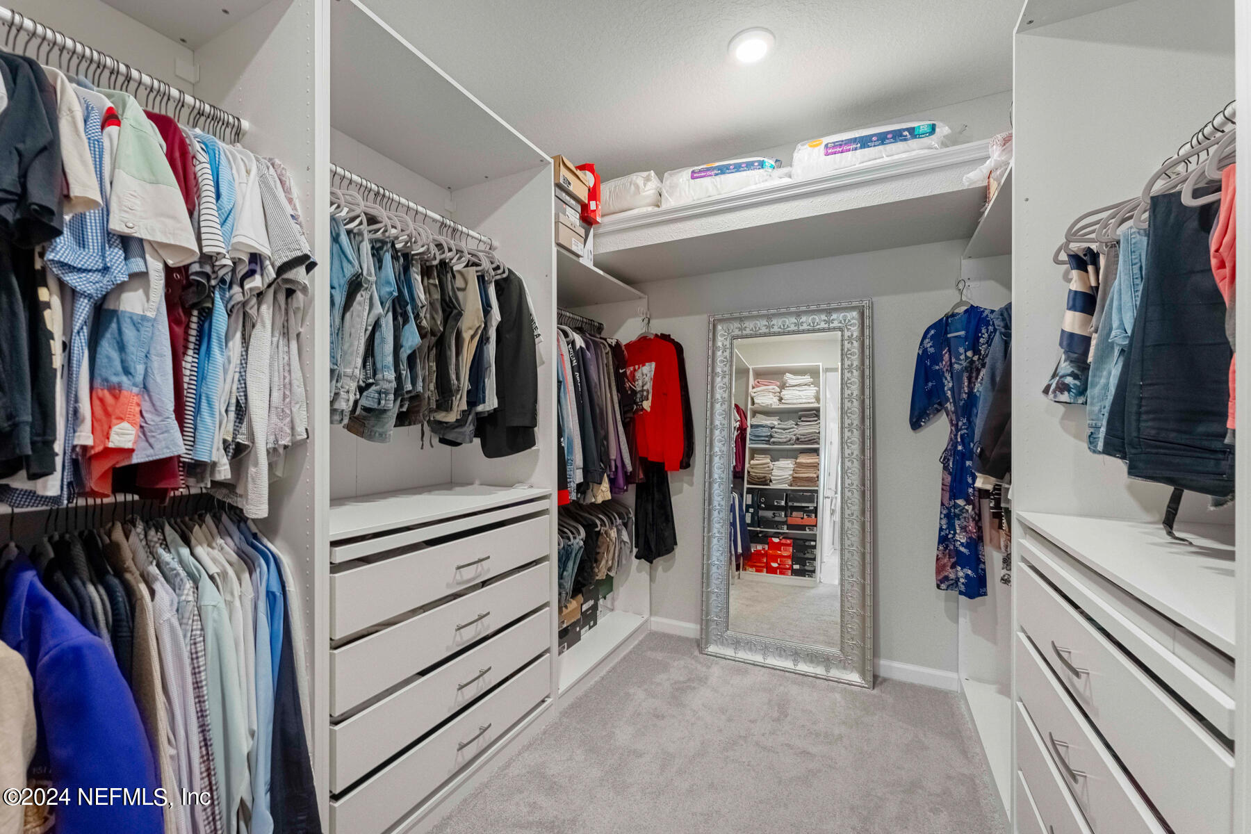 10279 Innovation Way Jacksonville, FL 32256 - Photo 22 of 42 a view of walk in closet with clothes and shoes