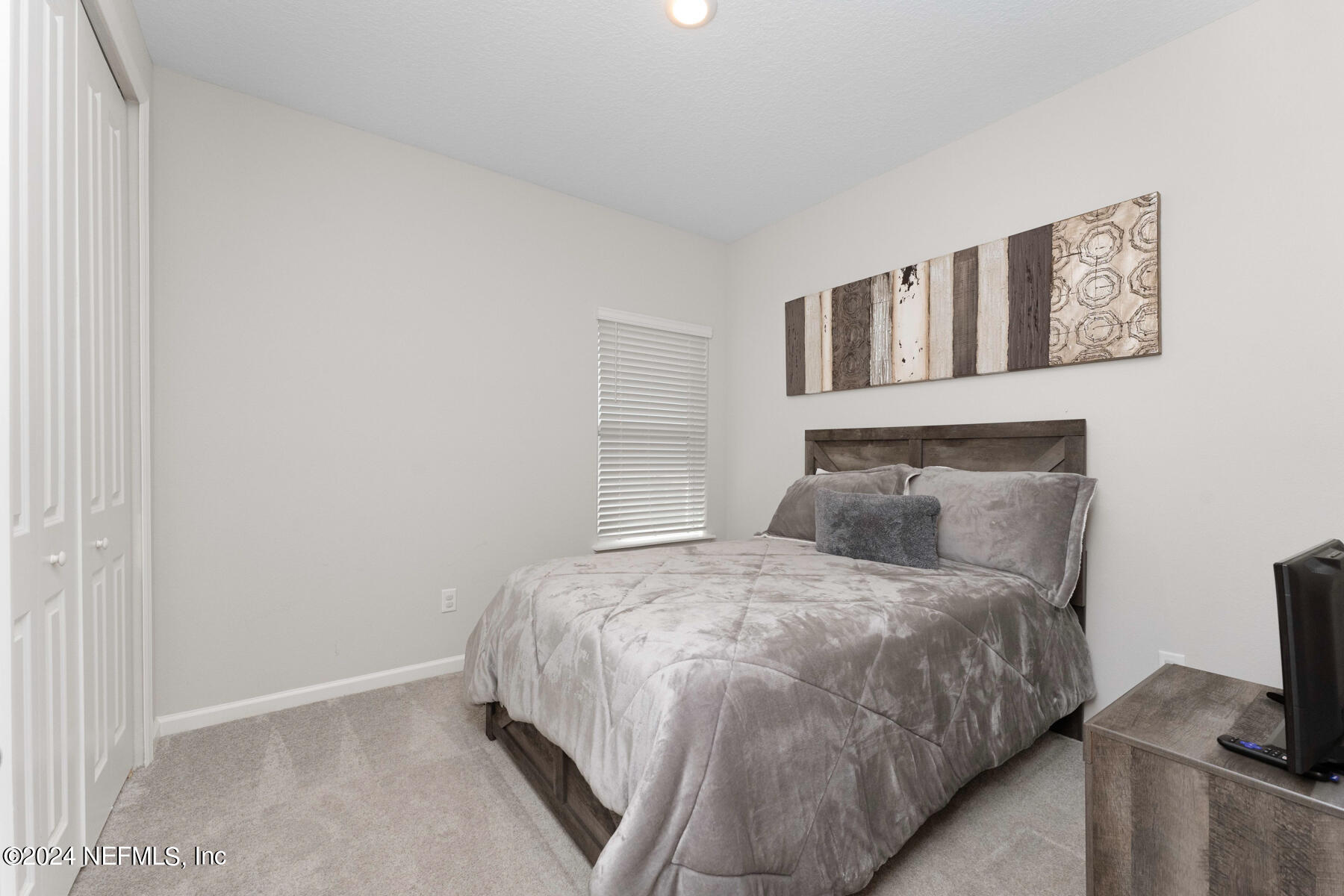 10279 Innovation Way Jacksonville, FL 32256 - Photo 26 of 42 a bedroom with a bed and painting on the wall