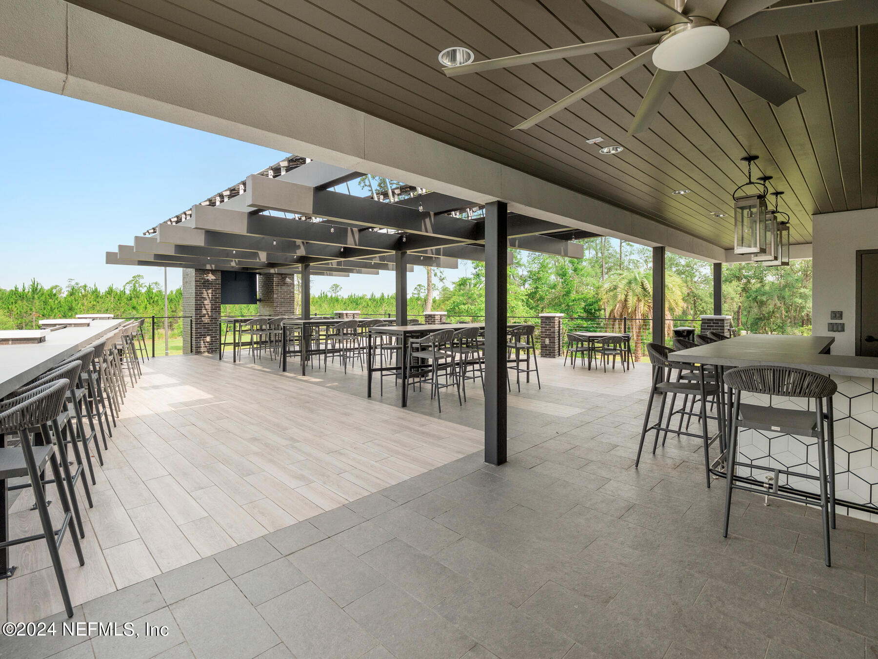 10279 Innovation Way Jacksonville, FL 32256 - Photo 37 of 42 a view of a patio with table and chairs potted plants with floor to ceiling window