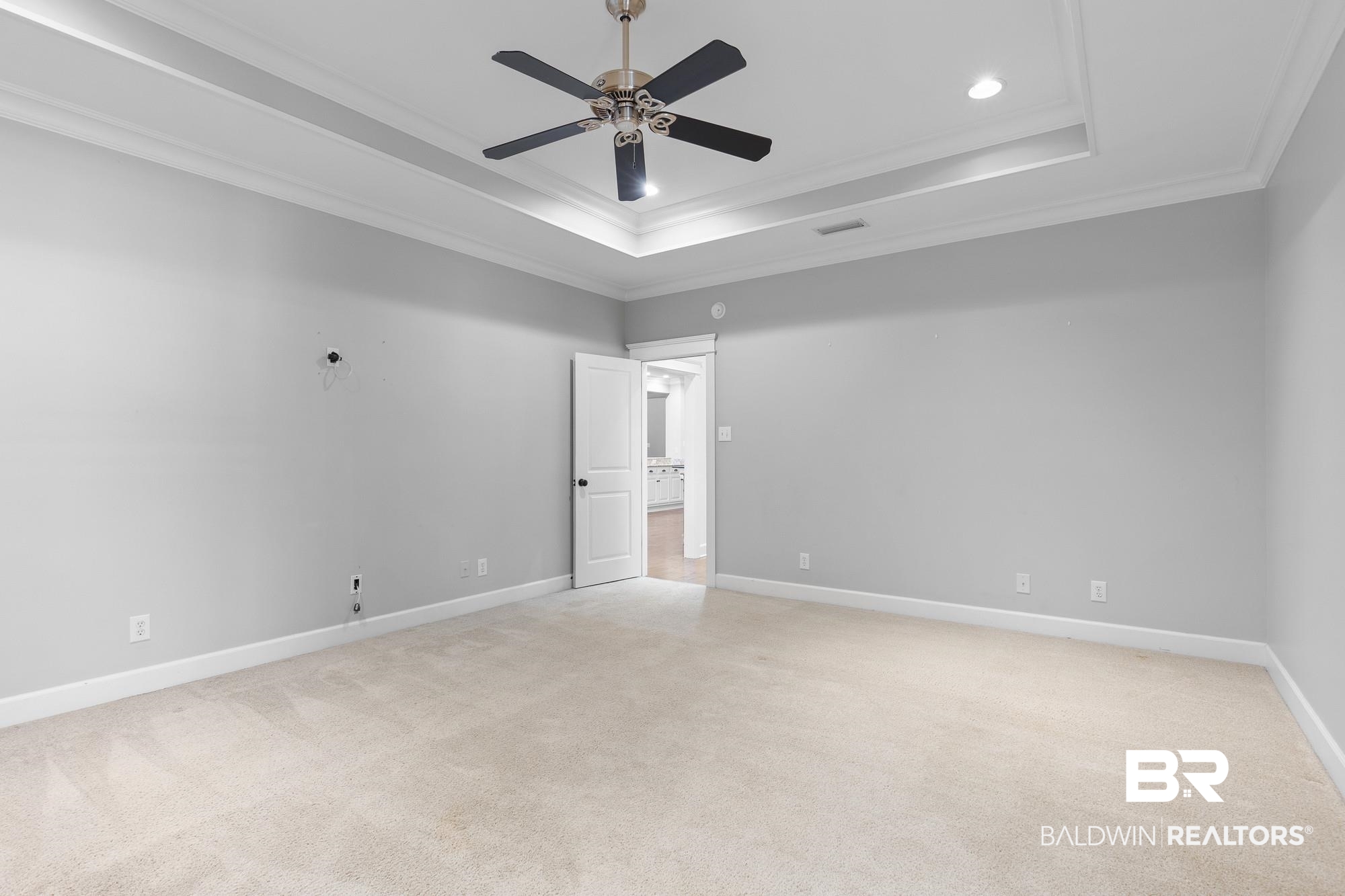 11261 Halcyon Loop Daphne, AL 36526 - Photo 16 of 41 Spacious room featuring tray ceilings, crown molding, a ceiling fan with integrated lighting, recessed lighting, and light-toned carpeting