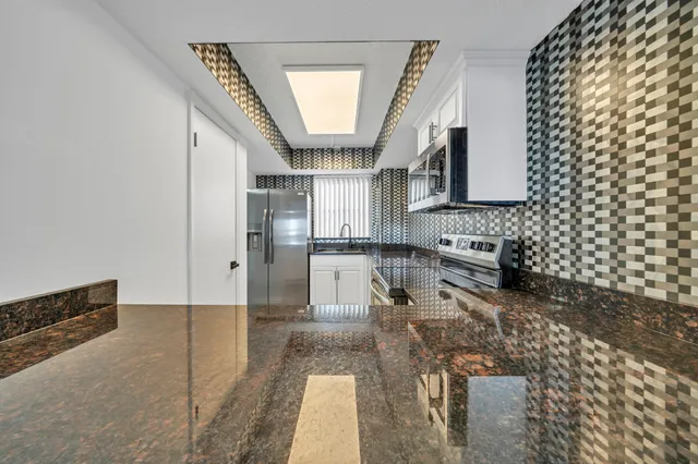 a view of a kitchen with a sink and a window