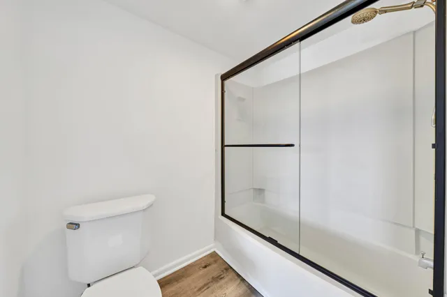 a bathroom with a granite countertop sink a toilet and a mirror