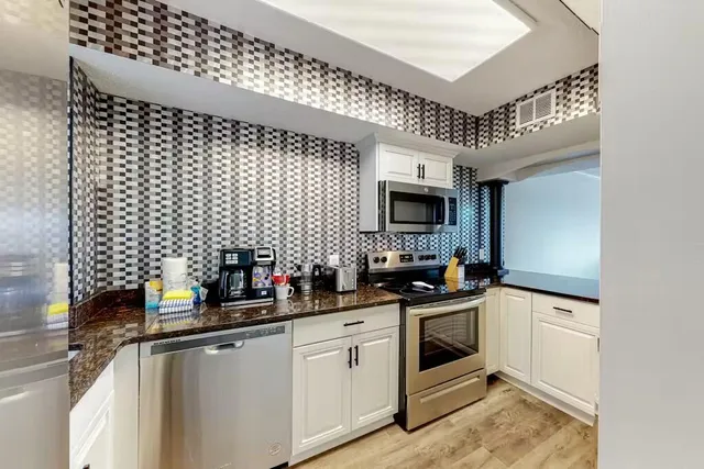 a kitchen with a sink a stove and microwave