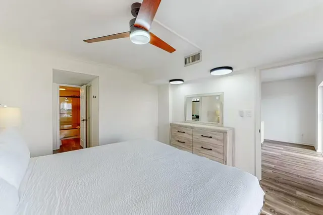 a bedroom with a bed and a dresser