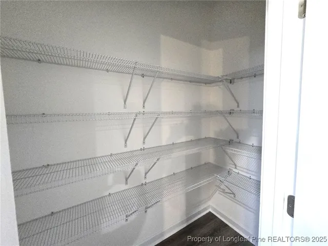 a view of a store room with racks on the wall