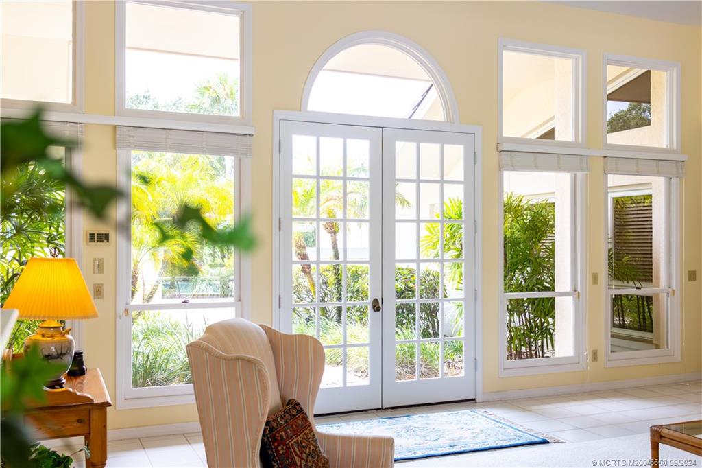 Undisclosed Address Stuart, FL 34997 - Photo 26 of 52 a living room with large windows