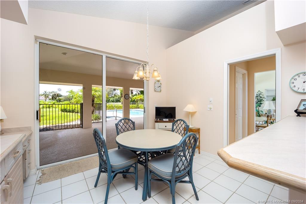 Undisclosed Address Stuart, FL 34997 - Photo 32 of 52 a dining room with furniture a chandelier and wooden floor
