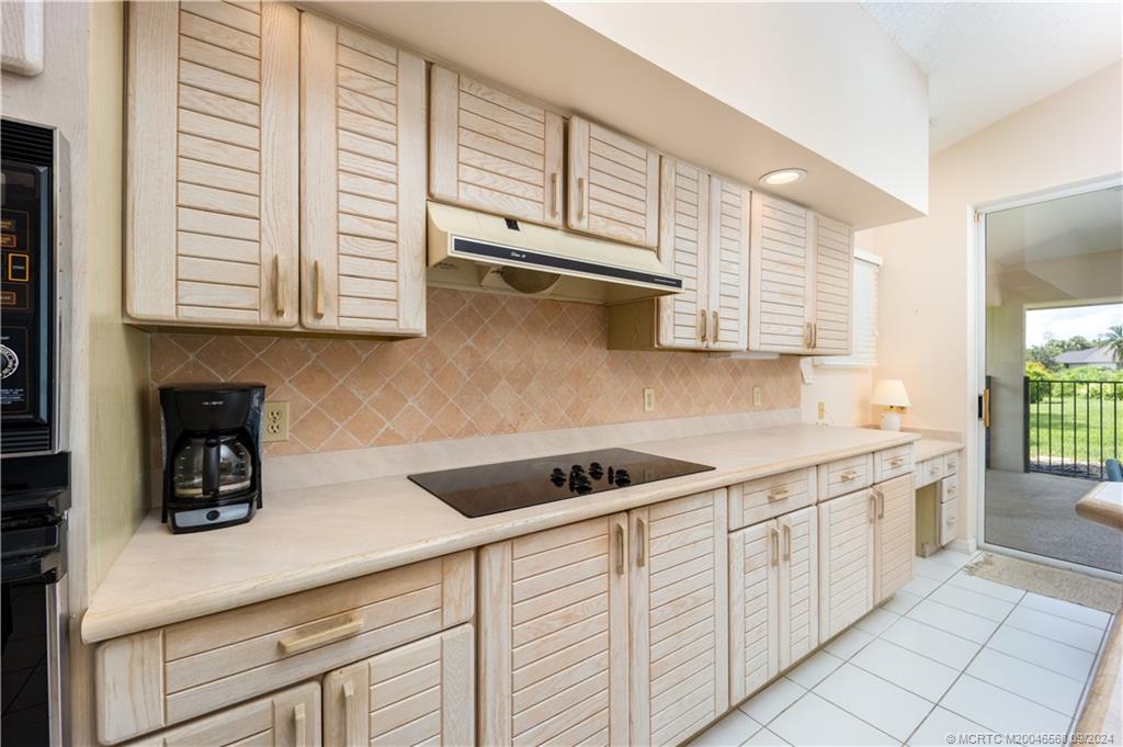 Undisclosed Address Stuart, FL 34997 - Photo 33 of 52 a kitchen with stainless steel appliances granite countertop a sink and a white cabinets