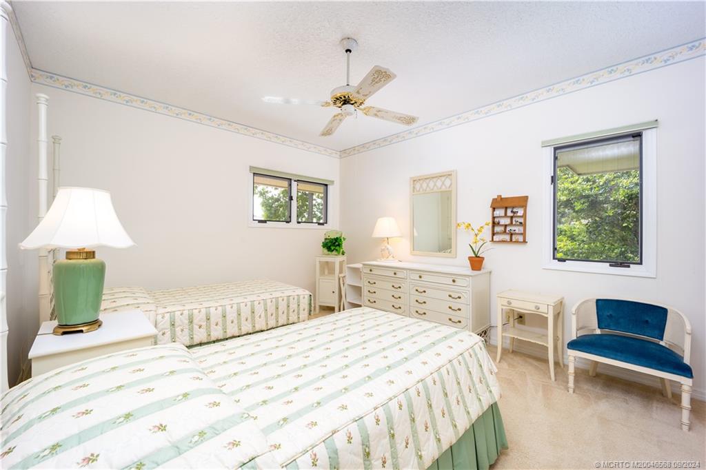 Undisclosed Address Stuart, FL 34997 - Photo 40 of 52 a bedroom with a bed and a chandelier