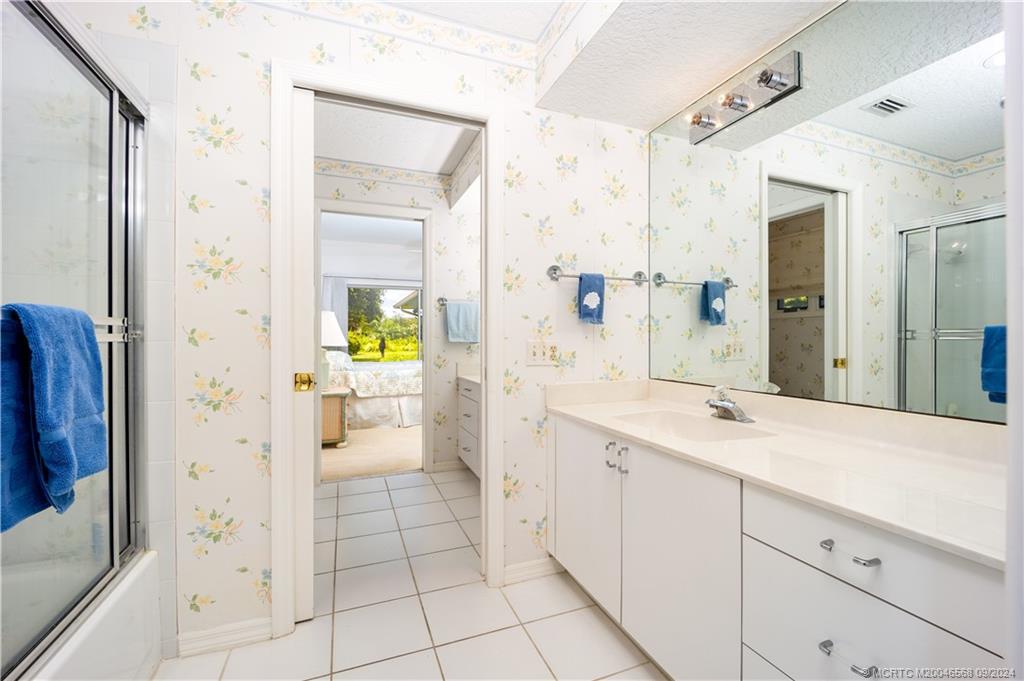 Undisclosed Address Stuart, FL 34997 - Photo 41 of 52 a spacious bathroom with a granite countertop sink mirror and shower