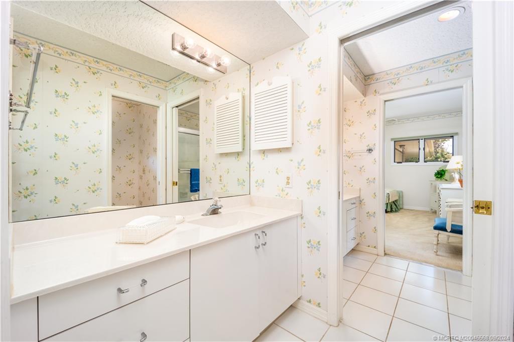 Undisclosed Address Stuart, FL 34997 - Photo 42 of 52 a spacious bathroom with a shower sink and mirror