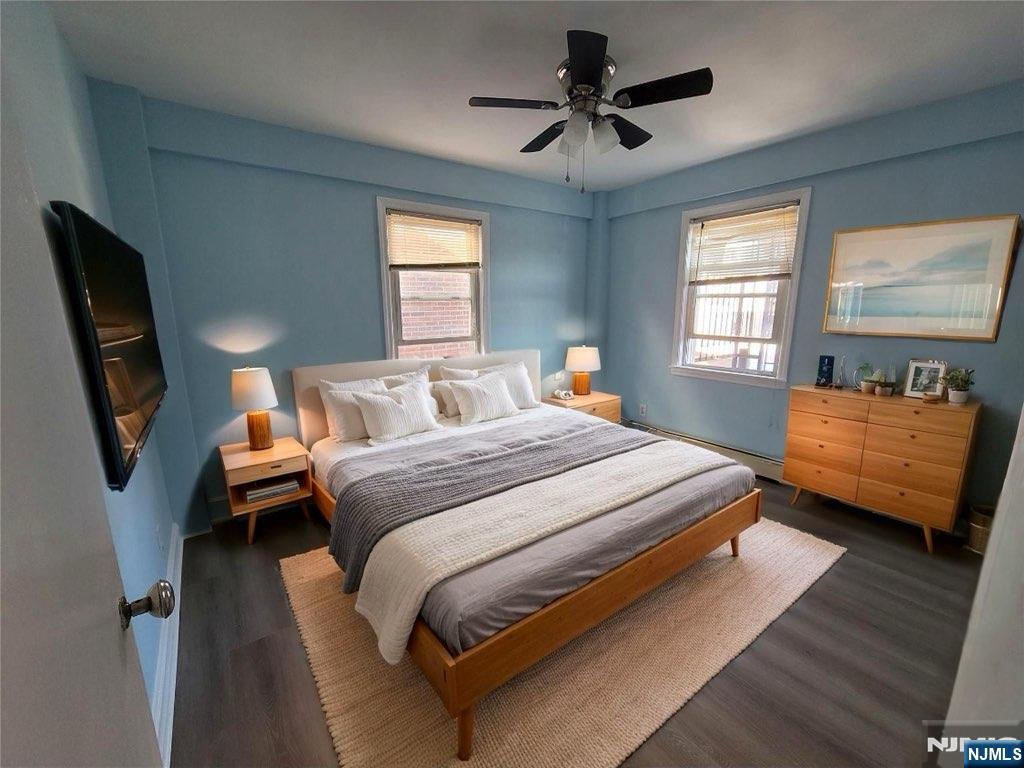 772 Devon Street, Unit 2 Kearny, NJ 07032 - Photo 2 of 10 a bedroom with a bed a couch and dresser