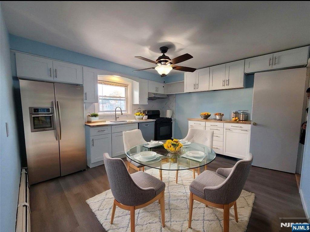 772 Devon Street, Unit 2 Kearny, NJ 07032 - Photo 4 of 10 a kitchen with stainless steel appliances granite countertop a dining table and chairs