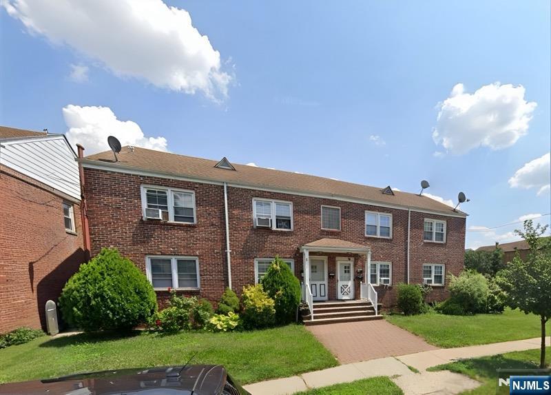 772 Devon Street, Unit 2 Kearny, NJ 07032 - Photo 5 of 10 a front view of a house with a yard