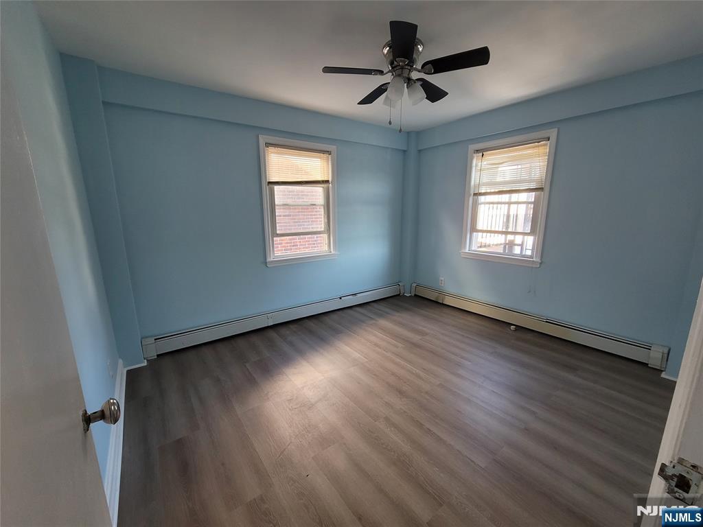 772 Devon Street, Unit 2 Kearny, NJ 07032 - Photo 8 of 10 a view of an empty room with wooden floor and a window