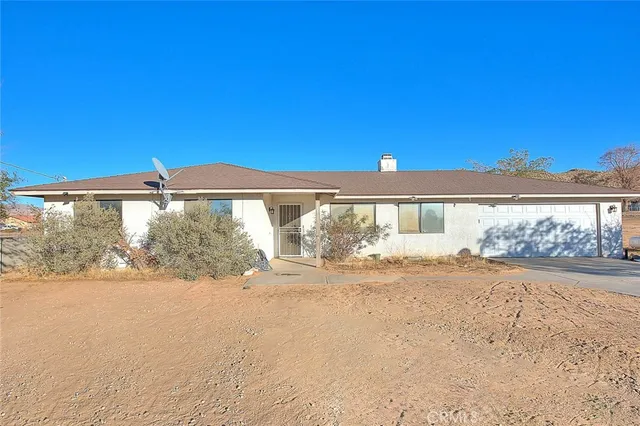 a view of a house with a yard and balcony