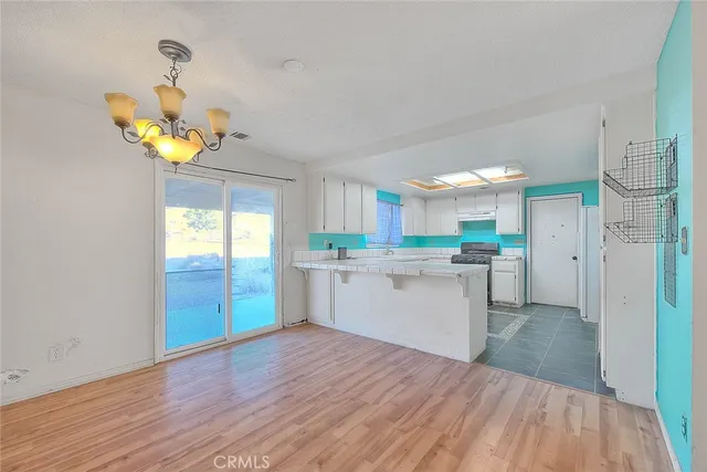 a kitchen with counter top space cabinets and wooden floor