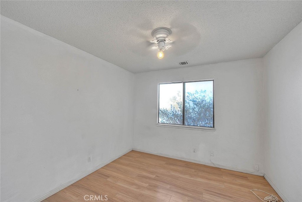 14811 Kingsdale Road Apple Valley, CA 92307 - Photo 24 of 57 wooden floor in an empty room with a window